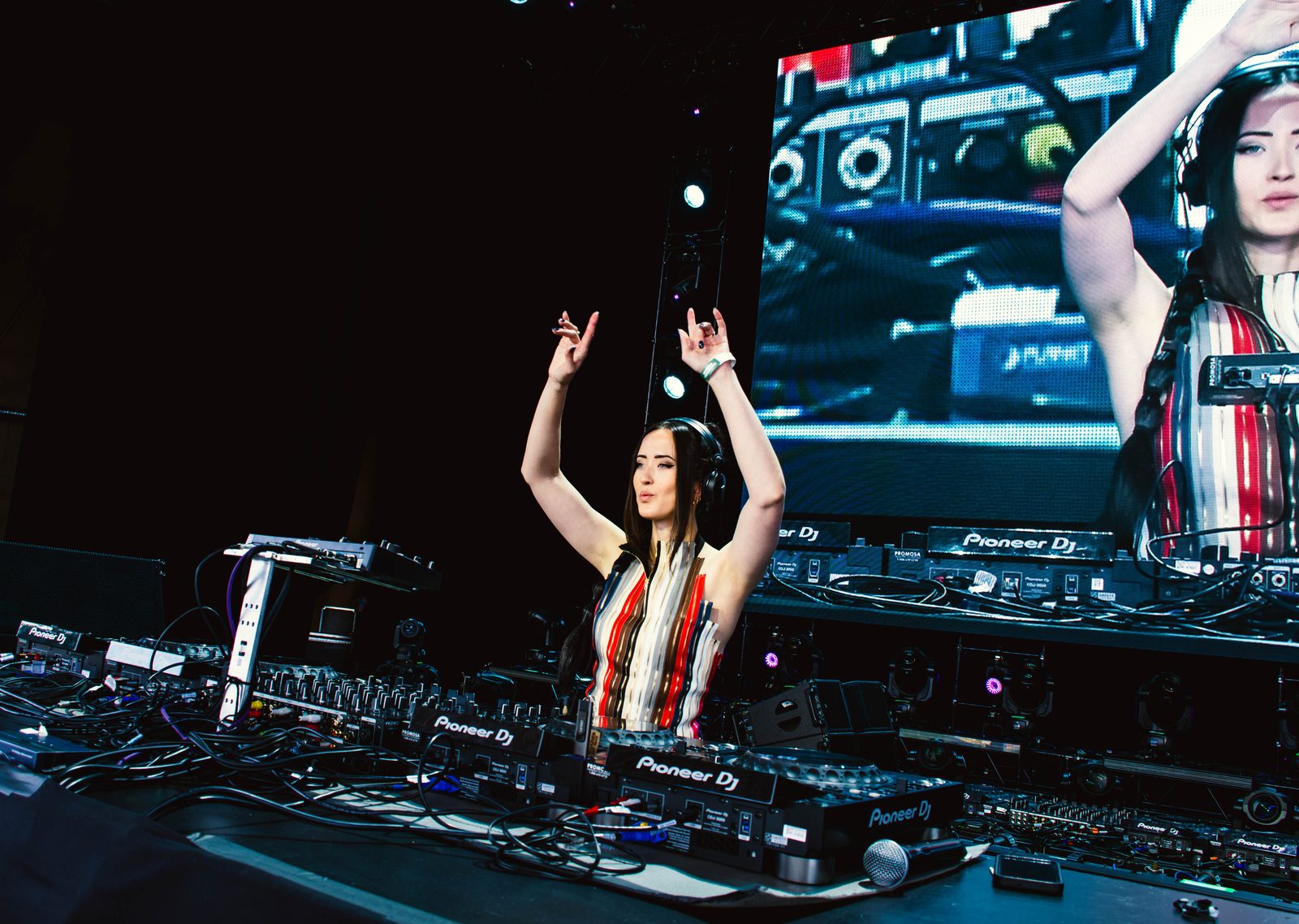 Shades of Day performing behind the decks under coloured stage lighting